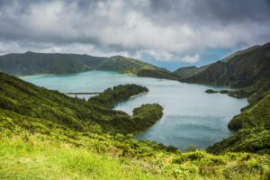 Breathtaking view of Lagoa do Fogo surrounded by lush greenery and mountains in the Azores.