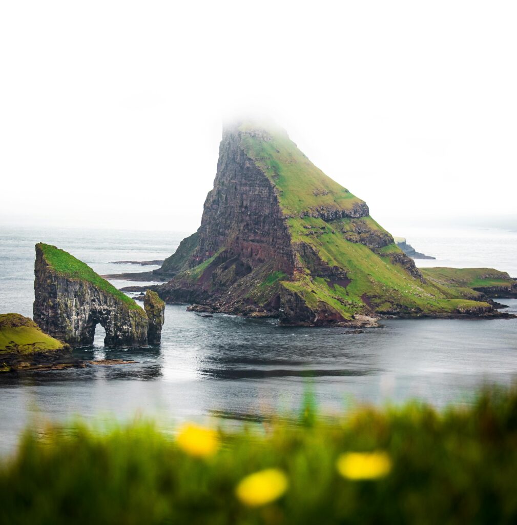 Scenic view of Drangarnir and Tindhólmur Island enveloped in fog, Faroe Islands.